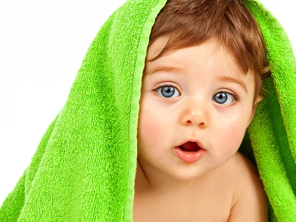 Image Of Cute Baby Boy Covered With Green Towel Isolated On White Background